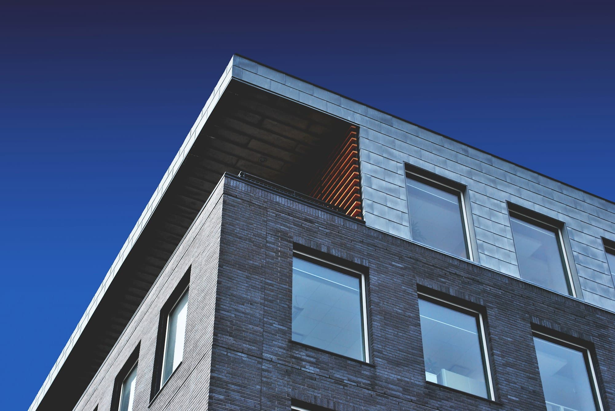 Modern building facade against a deep blue sky