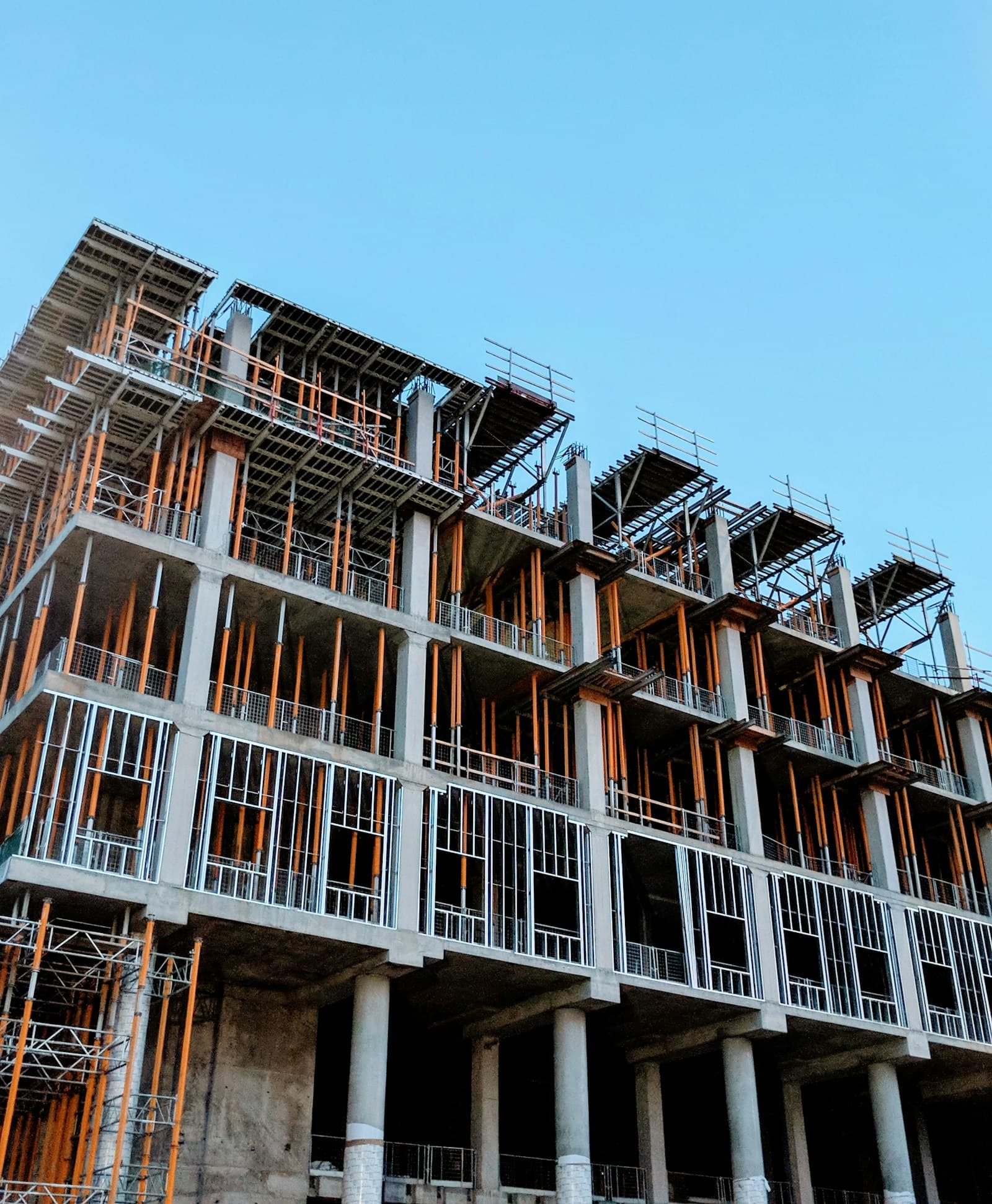 Building frame under construction against a clear sky