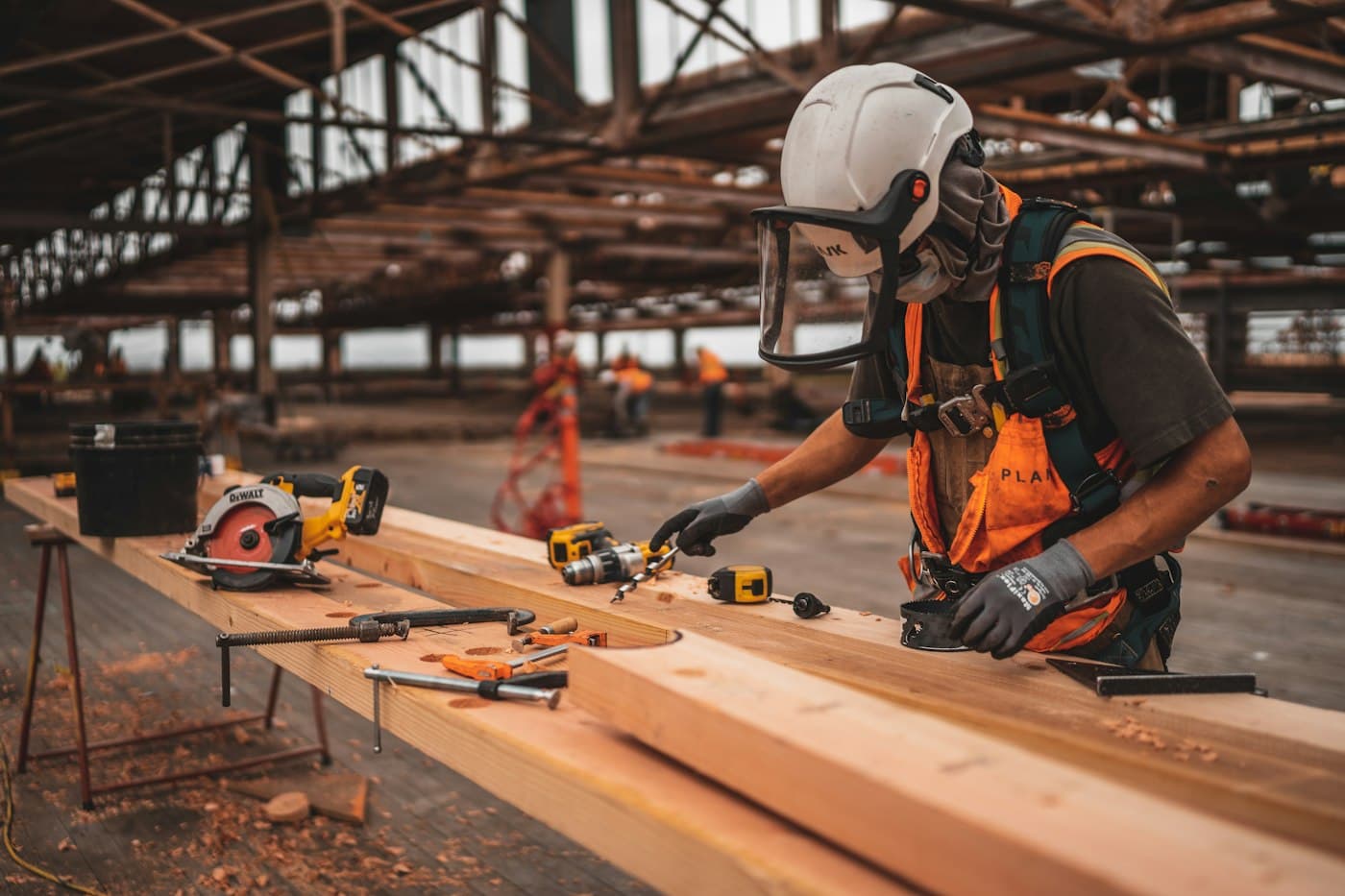 Craftsman cutting timber on site